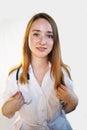 Female doctor in lab coat with Stethoscope against white background. Royalty Free Stock Photo