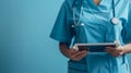 Female doctor in lab coat using digital tablet to review medical records. Royalty Free Stock Photo