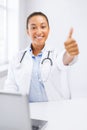 Female doctor with laptop showing thumbs up Royalty Free Stock Photo