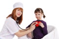 Female doctor and little girl holding plush heart