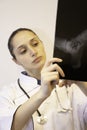 female doctor looking closely at an x-ray plate Royalty Free Stock Photo