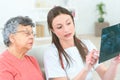 Female doctor looking at xray with senio patient