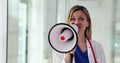 Female doctor makes announcement through megaphone