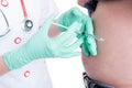 Female doctor making injection in abdomen to a diabetes patient