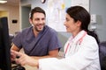Female Doctor With Male Nurse Working At Nurses Station Royalty Free Stock Photo