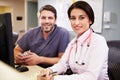 Female Doctor With Male Nurse Working At Nurses Station Royalty Free Stock Photo