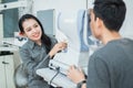 a female doctor and a male patient doing an eye check using a device Royalty Free Stock Photo