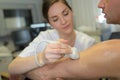 Female doctor with male patient undergoing arm echography