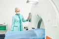 Female doctor in mask assisting during MRI for man Royalty Free Stock Photo