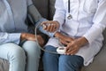 Female doctor measure blood pressure of elderly patient Royalty Free Stock Photo