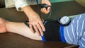 Female doctor measures blood pressure in a patient