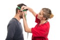 Female doctor measuring male patient head