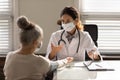 Female doctor examine elderly woman patient in clinic Royalty Free Stock Photo