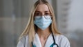 Female doctor in medical mask looking at camera talking angry show index finger no negative gesture mad stressed woman