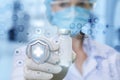 A female doctor in the medical mask is showing a vaccine in her hand in rubber glove .