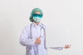 Female doctor in medical uniform and mask holding blank white banner Royalty Free Stock Photo