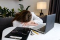 Female doctor in medical uniform sleep in consulting room. Tired exhausted young woman sitting at desk, working on computer with Royalty Free Stock Photo