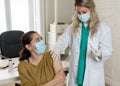 Female doctor or nurse giving shot or vaccine to a patient. Vaccination and prevention concept Royalty Free Stock Photo