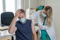 Female doctor or nurse giving shot or vaccine to a patient. Vaccination and prevention concept Royalty Free Stock Photo