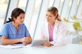 Female Doctor And Nurse Having Meeting