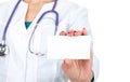 Female doctor or nurse holding and showing blank empty business card Royalty Free Stock Photo