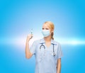 Female doctor or nurse in mask holding syringe Royalty Free Stock Photo