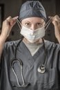 Female Doctor or Nurse with Stethoscope Putting On Protective Face Mask Royalty Free Stock Photo