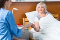 Female doctor or nurse in uniform is giving pills to her patient Royalty Free Stock Photo