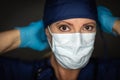 Female Doctor or Nurse Wearing Surgical Gloves Putting On Medical Face Mask Royalty Free Stock Photo