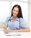 Female doctor or nurse writing prescription