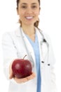 Female doctor offering an apple Royalty Free Stock Photo