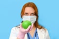 Female doctor offers a natural fruit diet on a blue background