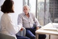 Female Doctor In Office Reassuring Senior Man Patient And Holding His Hands Royalty Free Stock Photo