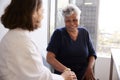 Female Doctor In Office Reassuring Senior Woman Patient And Holding Her Hands Royalty Free Stock Photo