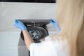 Female doctor opens a centrifuge for plasmolifting.