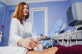 Female doctor operating ultrasound scanner