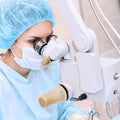 Female doctor at operation room near microscope Royalty Free Stock Photo