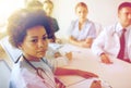 Female doctor over group of medics at hospital Royalty Free Stock Photo