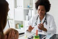 Female doctor pediatrician with baby patient and mother Royalty Free Stock Photo