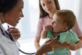 Female doctor pediatrician with baby patient and mother Royalty Free Stock Photo