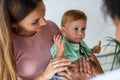 Female doctor pediatrician with baby patient and mother Royalty Free Stock Photo