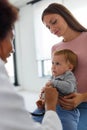 Female doctor pediatrician with baby patient and mother Royalty Free Stock Photo