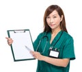 Female doctor pen point to clipboard with white paper Royalty Free Stock Photo