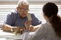 Female doctor pharmacist recommend effective pills to senior man oap