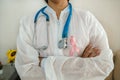 Female doctor with pink breast cancer awareness ribbon, healthcare and medicine concept Royalty Free Stock Photo