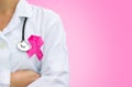 Female doctor with pink breast cancer awareness ribbon Royalty Free Stock Photo