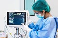 Female doctor pointing to Heart rate monitor in operation room.Healthcare and Medical concept. Hospital and People theme. Royalty Free Stock Photo