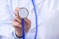 Female doctor portrait, young woman physican holding a stethoscope isolated on white background, close up, cropped view, copy