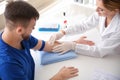 Female doctor preparing patient for blood draw in clinic Royalty Free Stock Photo