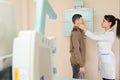 Female doctor preparing the patient for paranasal sinuses x-ray